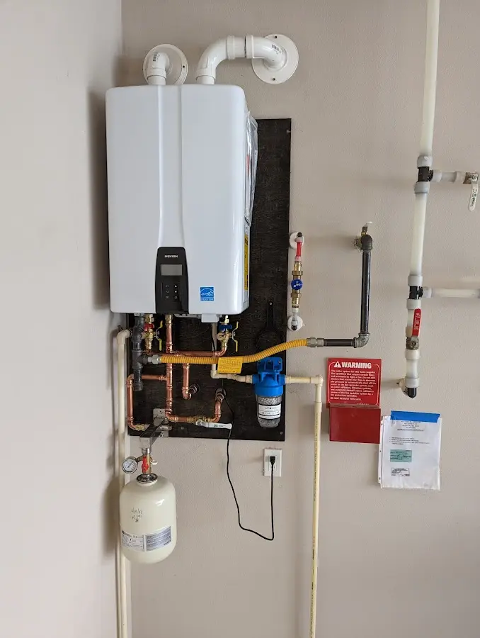 Professional plumber installing copper piping in a Shackle Island home